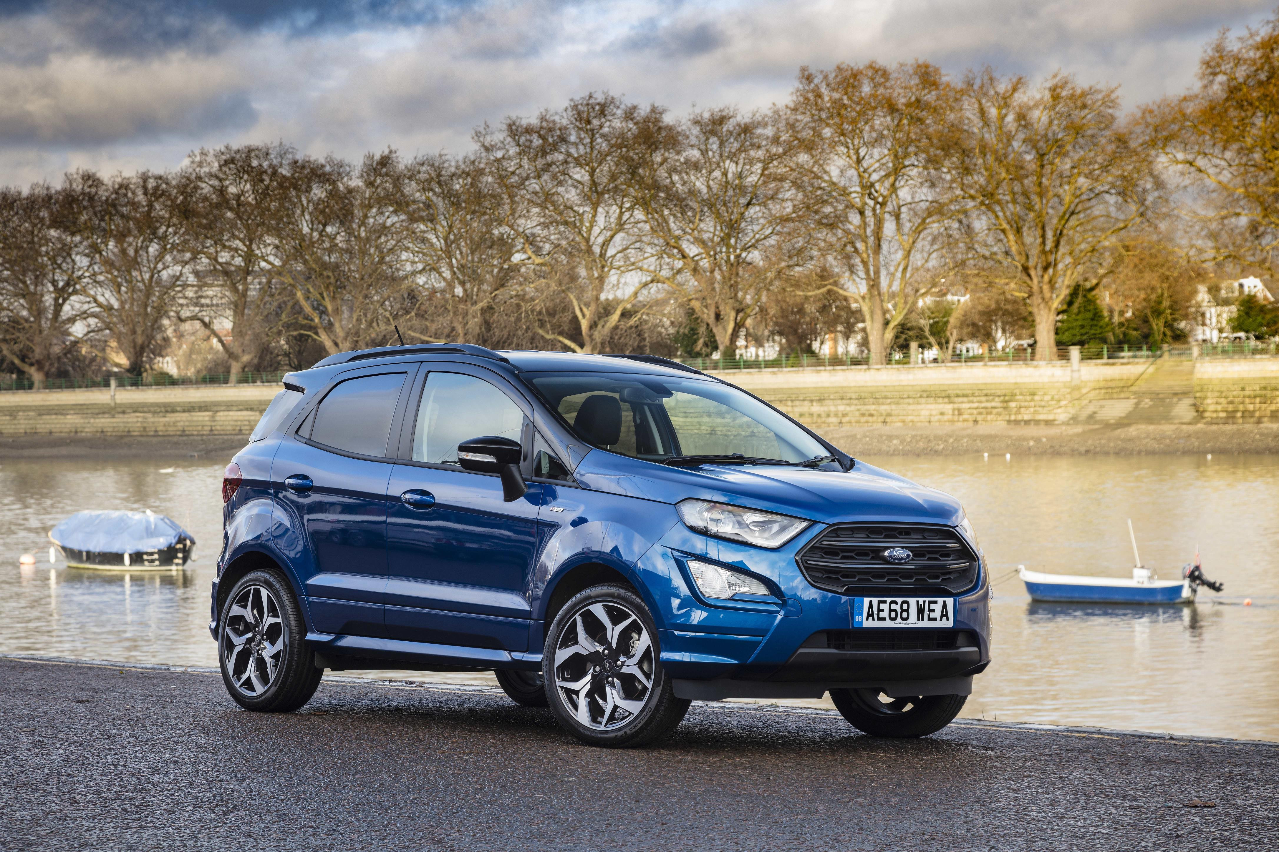 Blue Ford Ecosport parked facing three-quarters right, beside a boating lake.